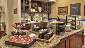 A breakfast buffet with various food items, including fruits, pastries, and hot beverages. - Hilton Garden Inn Las Cruces (Las Cruces)