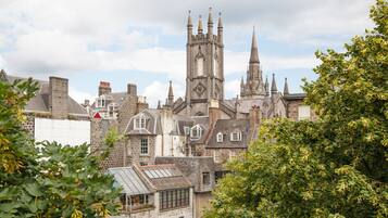 A historic building with multiple spires and a prominent clock tower.