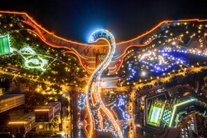 An aerial view of a brightly lit urban area with winding roads and illuminated pathways. - Sheraton Shunde Hotel (Foshan)