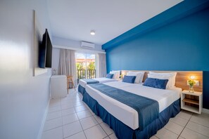 A hotel room with two beds, a TV, a small table with a vase, and a view of the outdoors. - Beach Park Acqua Resort (Aquiraz)