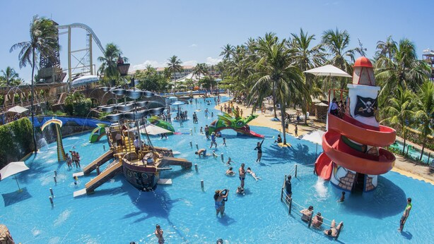 A large outdoor pool area with multiple water slides and a pirate-themed water tower. - Beach Park Acqua Resort (Aquiraz)