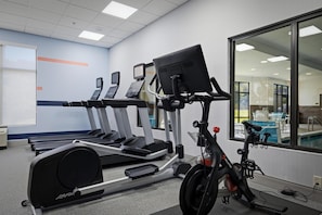 A gym with treadmills, a stationary bike, and a rowing machine. - Hampton Inn Hickory (Hickory)