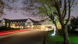 A traditional Tudor-style building with a symmetrical facade, large windows, and a central entrance. - ANEW Hotel Hilton Pietermaritzburg (Hilton)