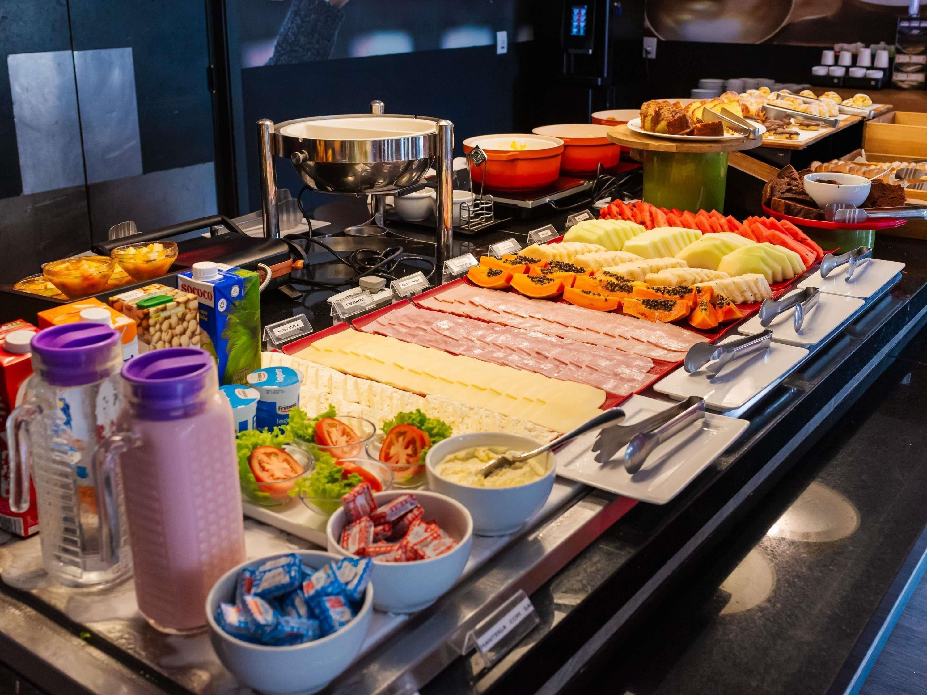 A buffet with various food items and condiments.