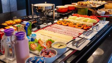 A buffet with various food items and condiments.