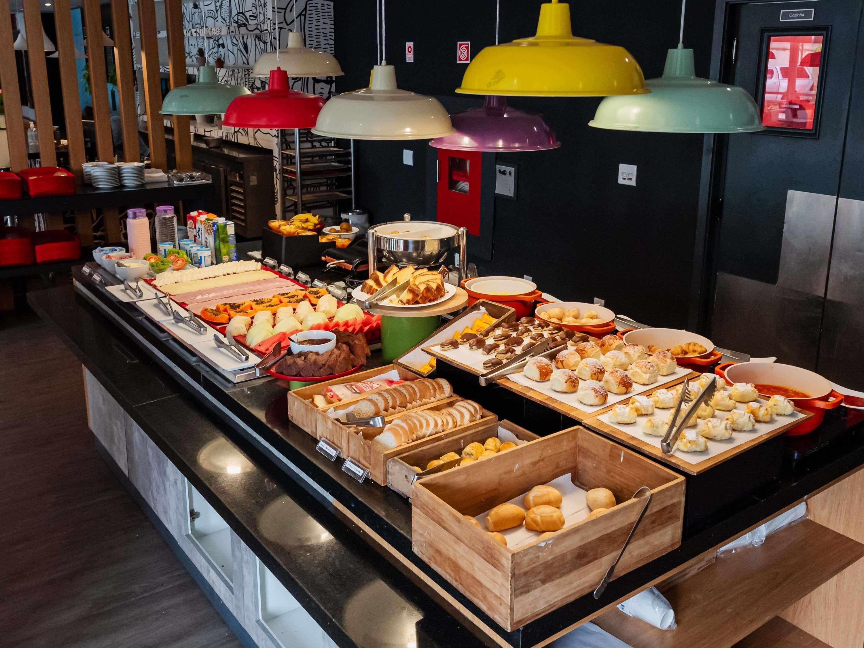 A buffet with various food items and utensils.