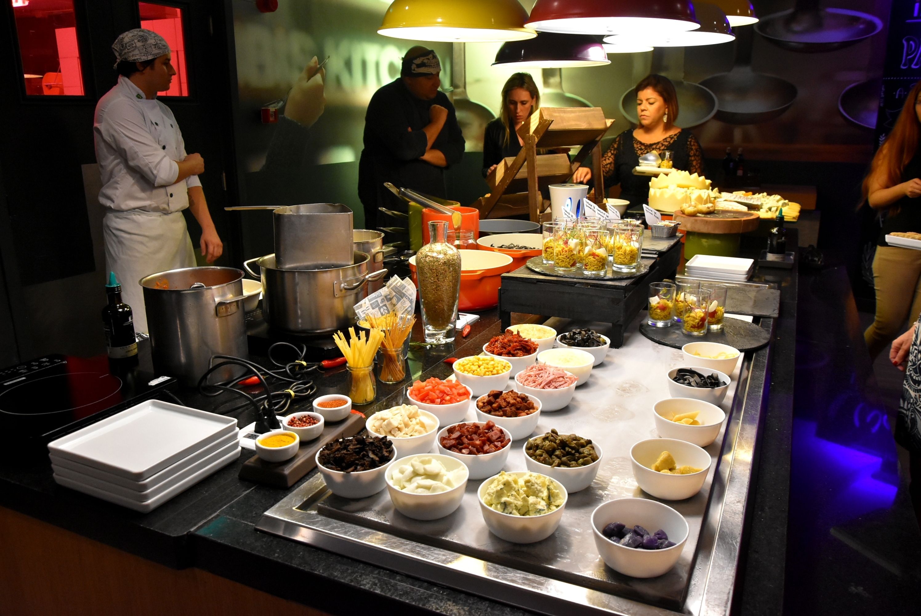 A buffet setup with various food items and serving utensils.