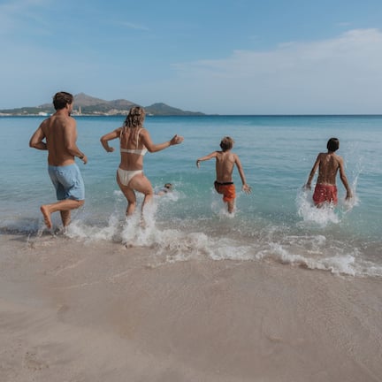 A beach scene with clear skies and calm water.