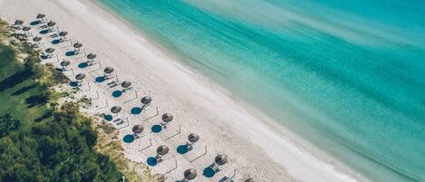 On the beach, white sand, beach umbrellas, beach towels
