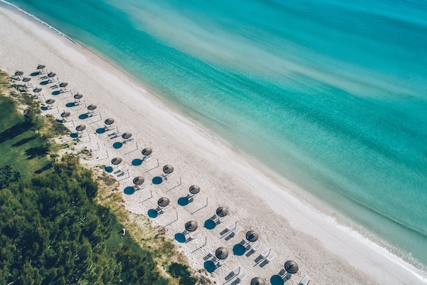 On the beach, white sand, beach umbrellas, beach towels