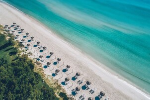 On the beach, white sand, beach umbrellas, beach towels