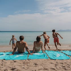 On the beach, white sand, beach umbrellas, beach towels