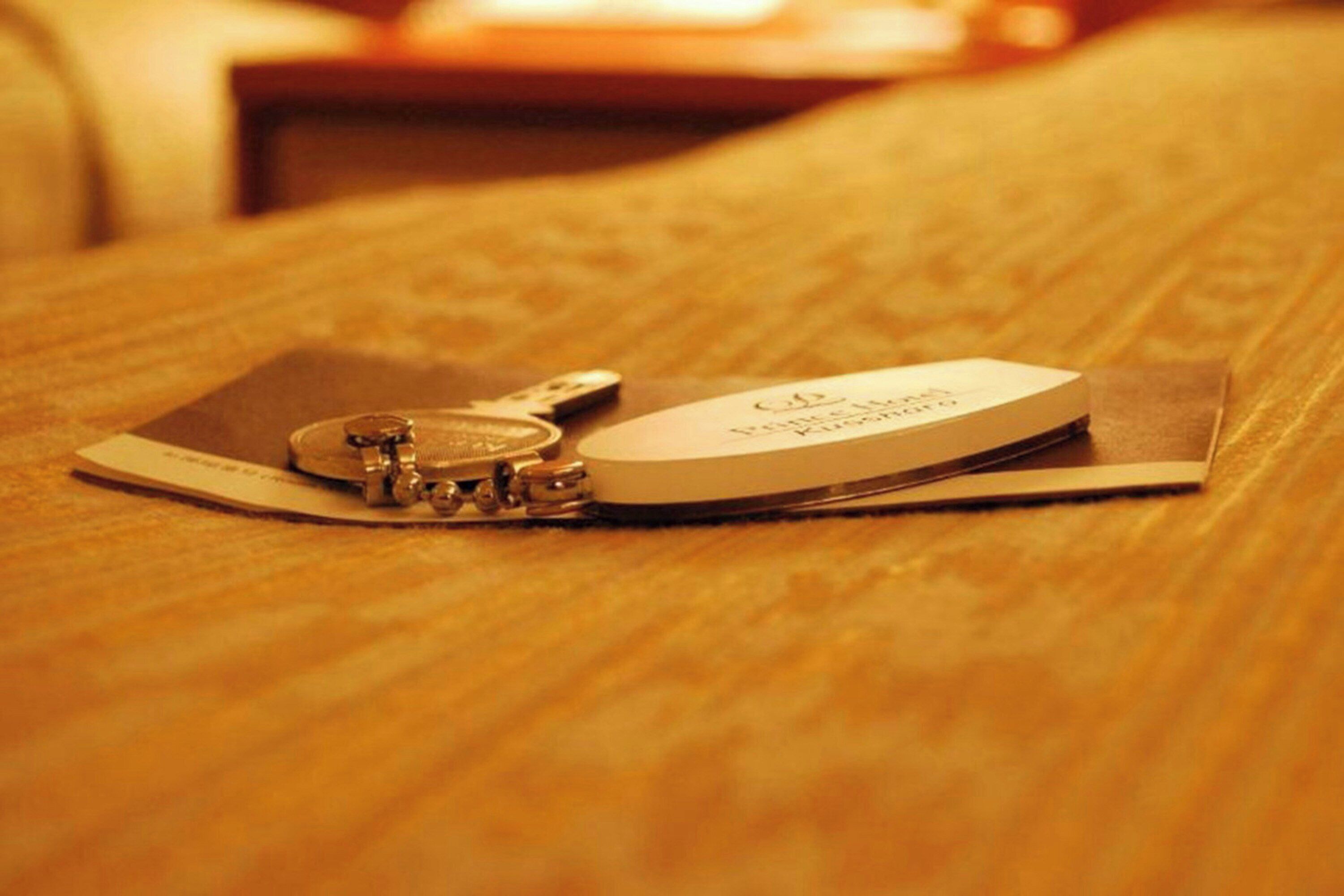 A metallic object on a wooden surface with a label.