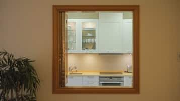 A kitchen with white cabinets, a sink, and a countertop.