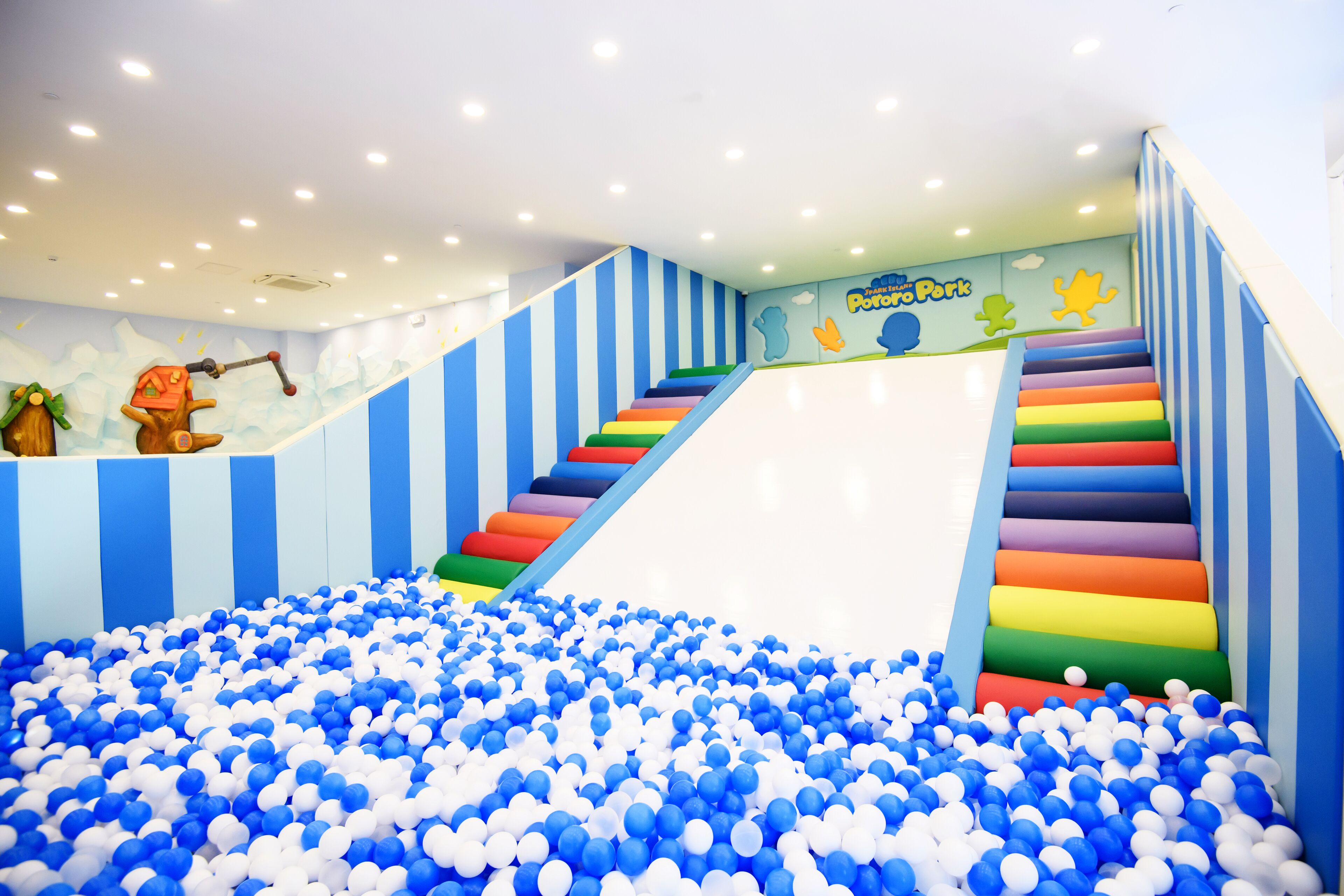 A children's play area with a ball pit and a slide.