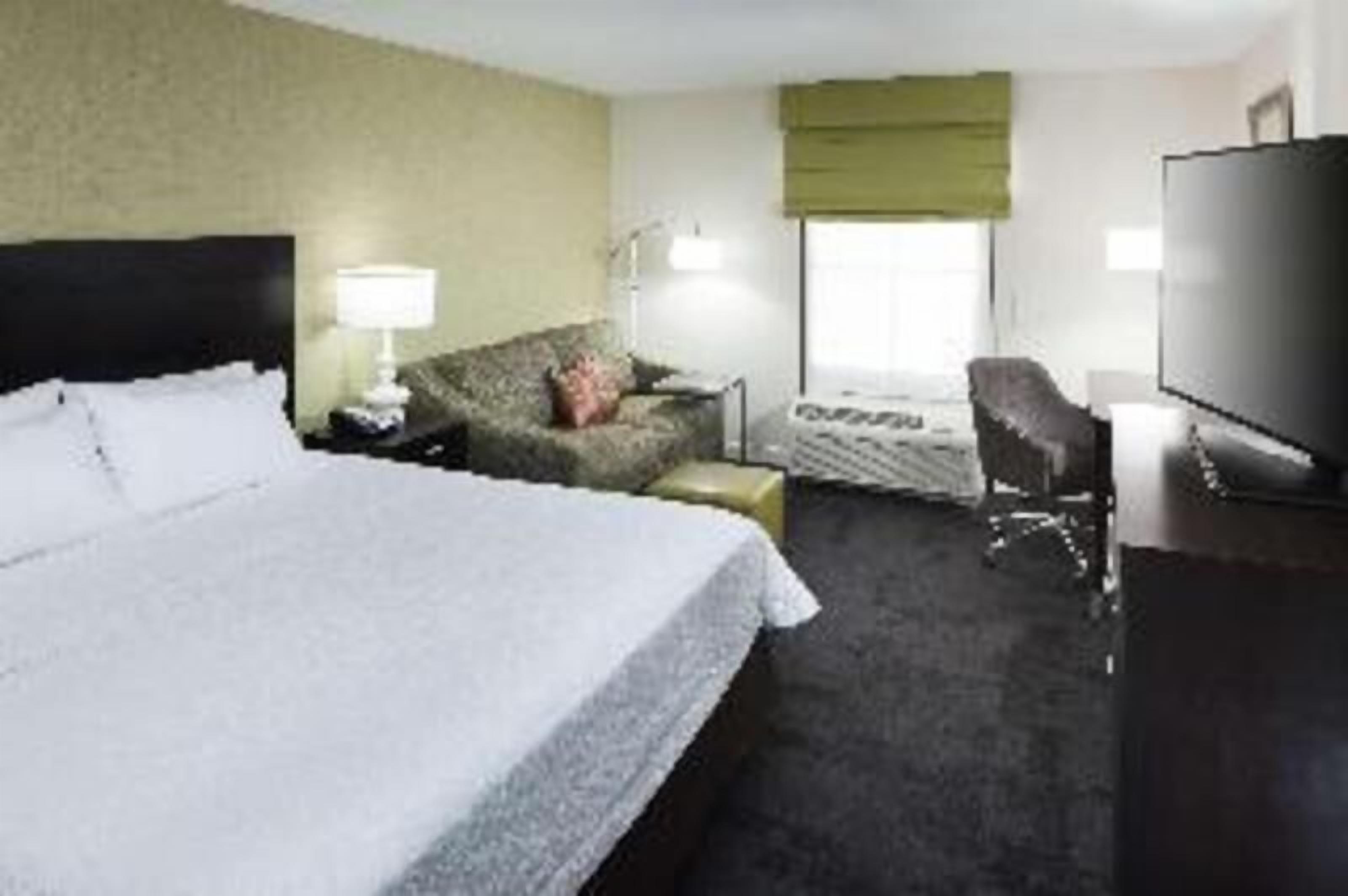 Premium bedding, desk, laptop workspace, blackout drapes