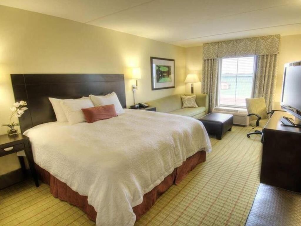 Premium bedding, desk, laptop workspace, blackout drapes