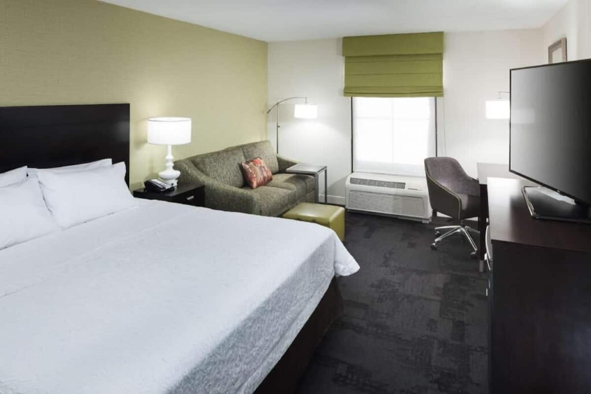 Premium bedding, desk, laptop workspace, blackout drapes