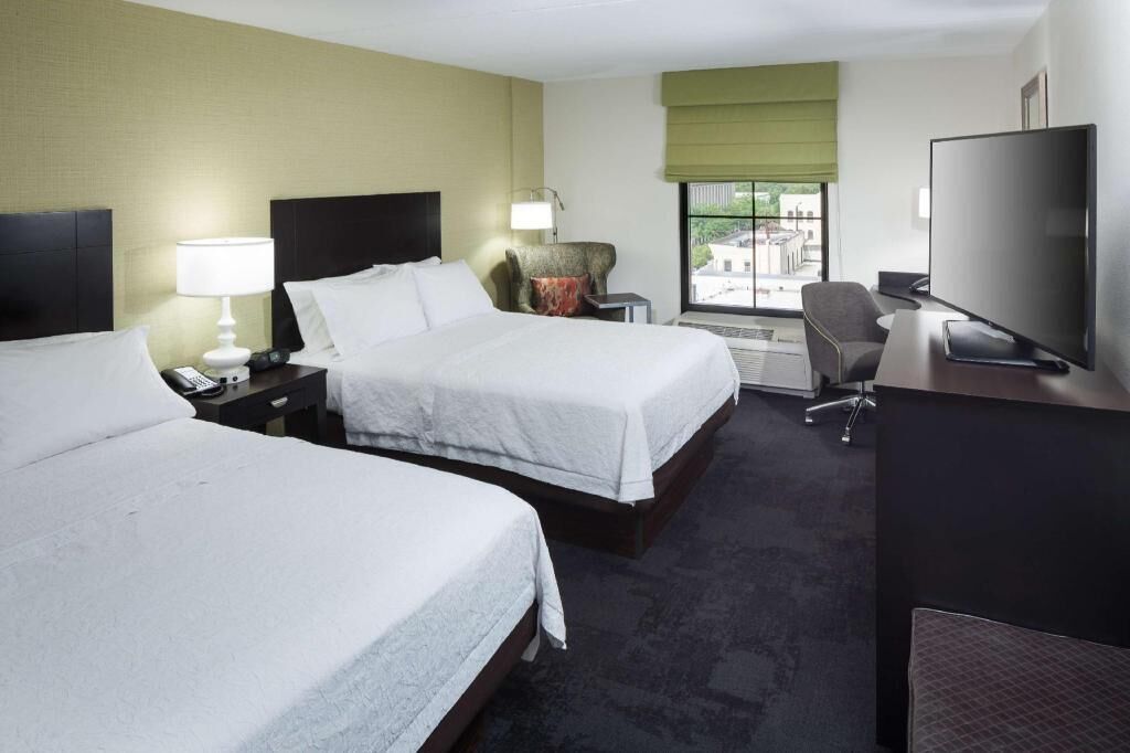 Premium bedding, desk, laptop workspace, blackout drapes