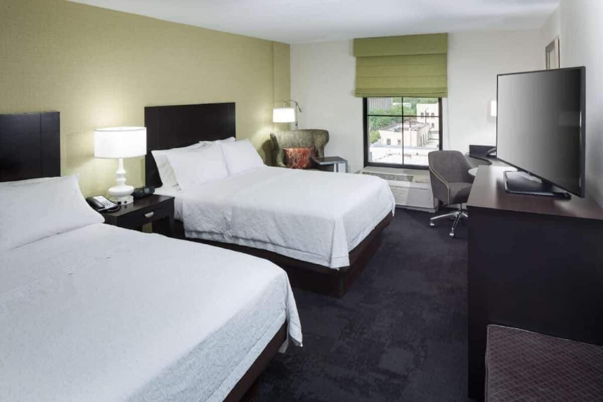 Premium bedding, desk, laptop workspace, blackout drapes