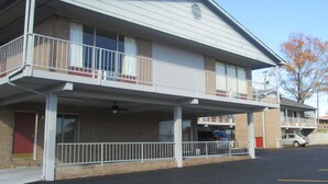 A two-story motel with a covered parking area and a single-story annex.