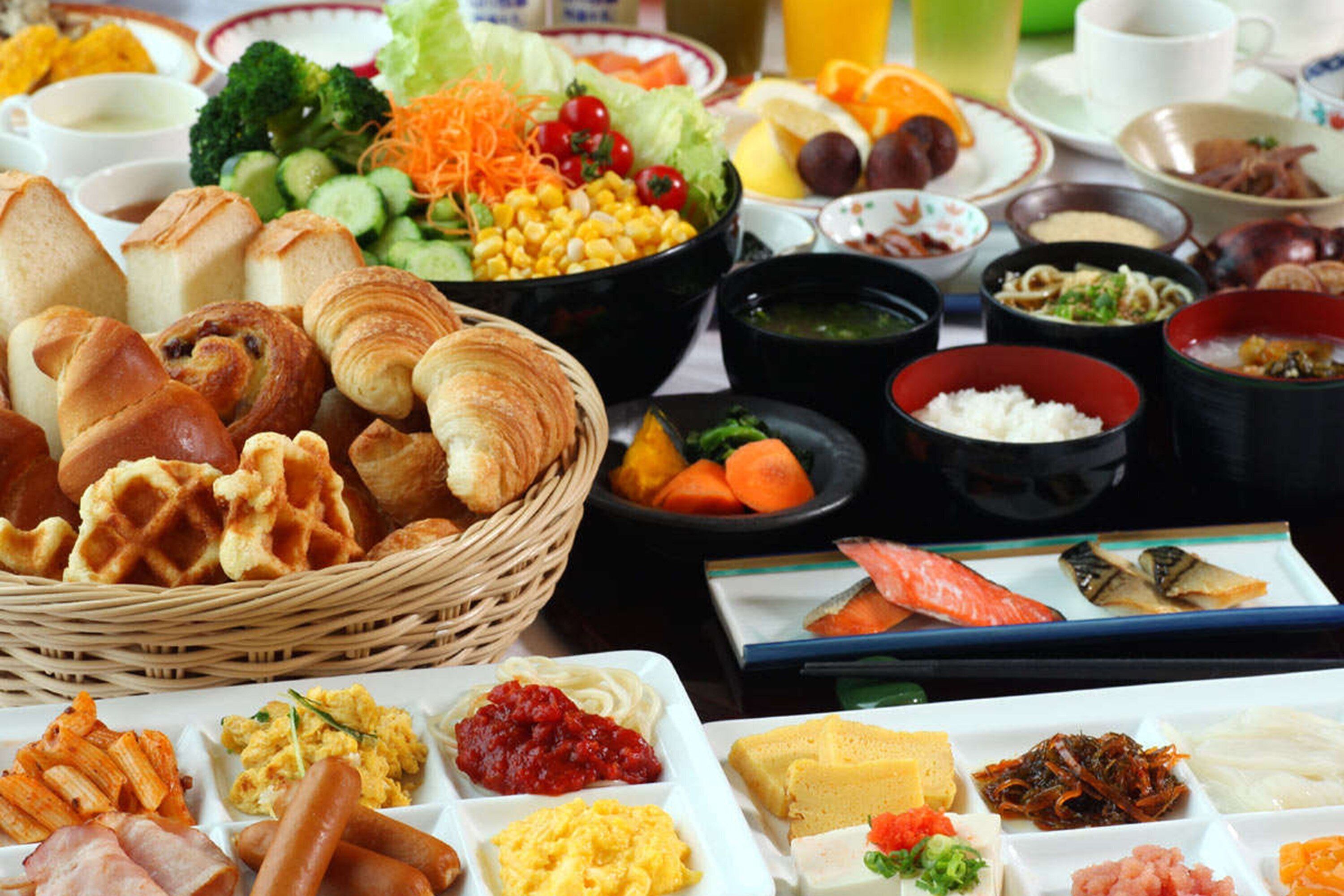 A buffet with various food items including bread, vegetables, and seafood.
