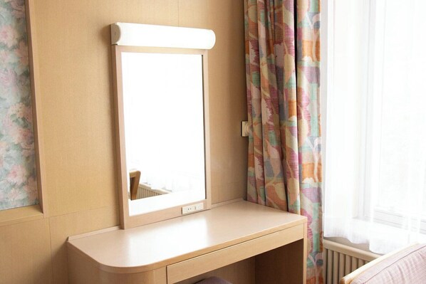 A room with a vanity table, a mirror, and a window with curtains. - Shiga Kogen Prince Hotel (Yamanouchi)