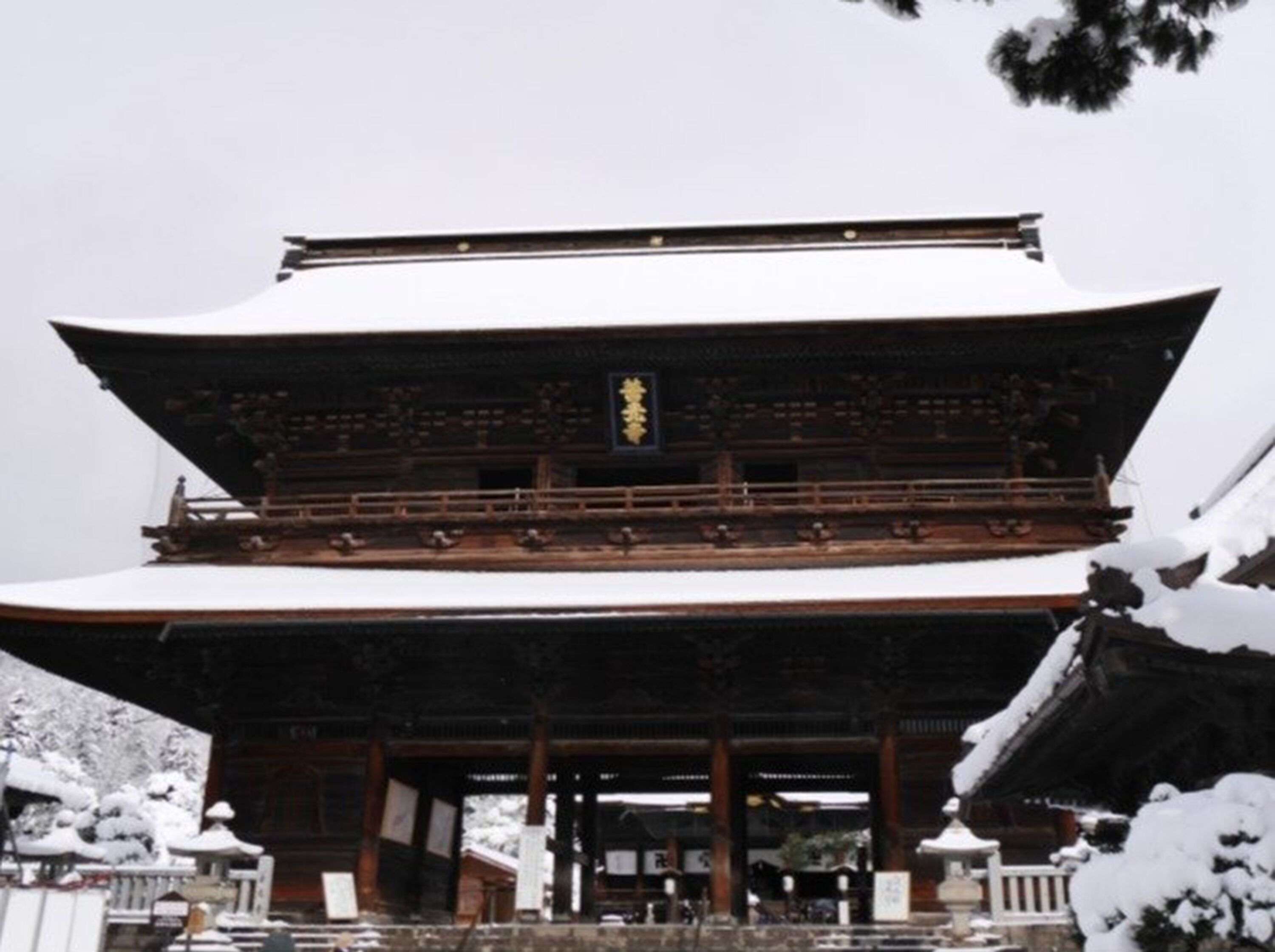 A traditional Japanese building with a multi-tiered roof and wooden construction.