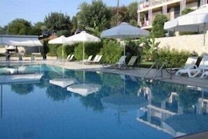 Seasonal outdoor pool, open 8 AM to 8 PM, pool umbrellas, pool loungers