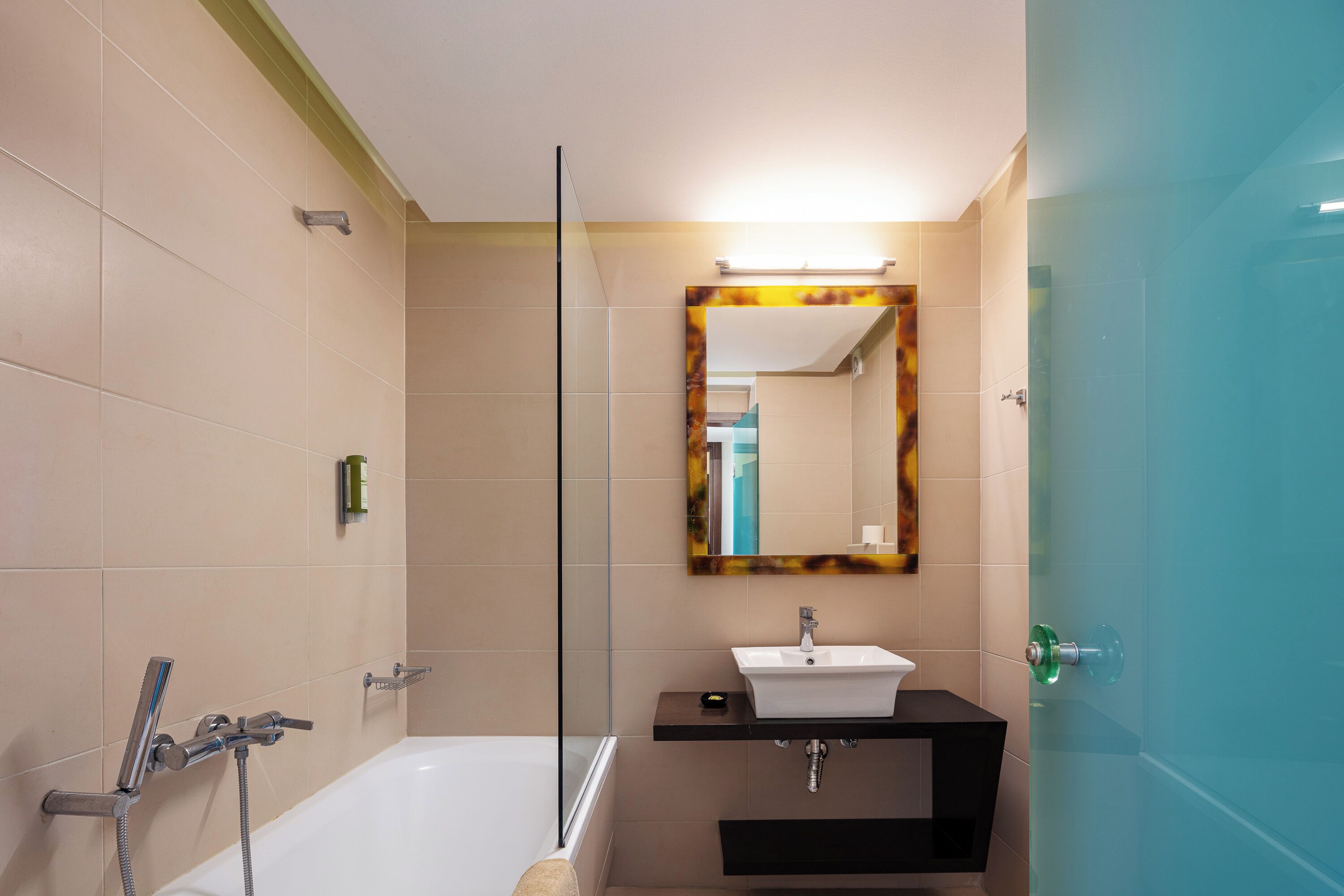 A modern bathroom with a bathtub, a sink, and a mirror.
