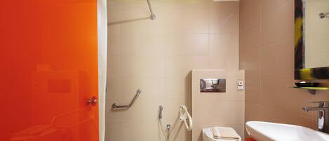 A bathroom with a shower, toilet, and sink.