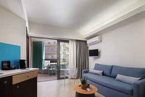 Apartment (Side Sea View) | Living area | 24-inch flat-screen TV with satellite channels, TV - Steris Elegant Beach Hotel  (Rethymno)