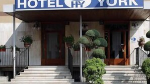 A hotel entrance with a sign reading "HOTEL YORK" and a crown symbol above the name. - Hotel York (Cinisello Balsamo)