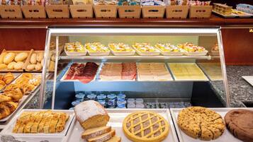A bakery display with various pastries and desserts.