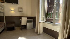 A bedroom with a bed, a desk, a TV, a window with curtains, and a nightstand. - B & B Evergreen (Rome)