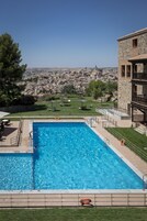 Seasonal outdoor pool, open 11:00 AM to 9:00 PM, pool umbrellas
