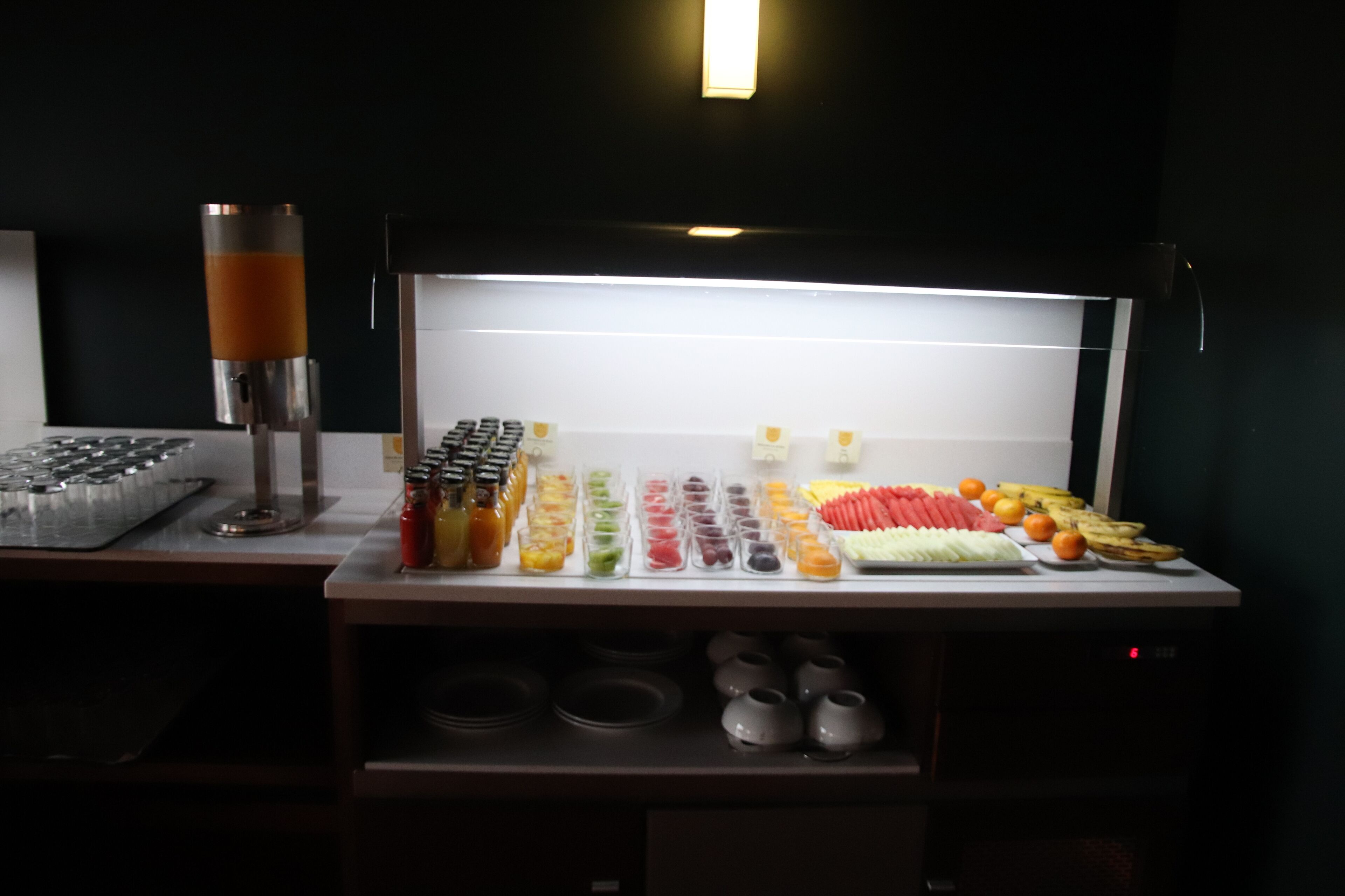 A buffet setup with various food items and condiments.