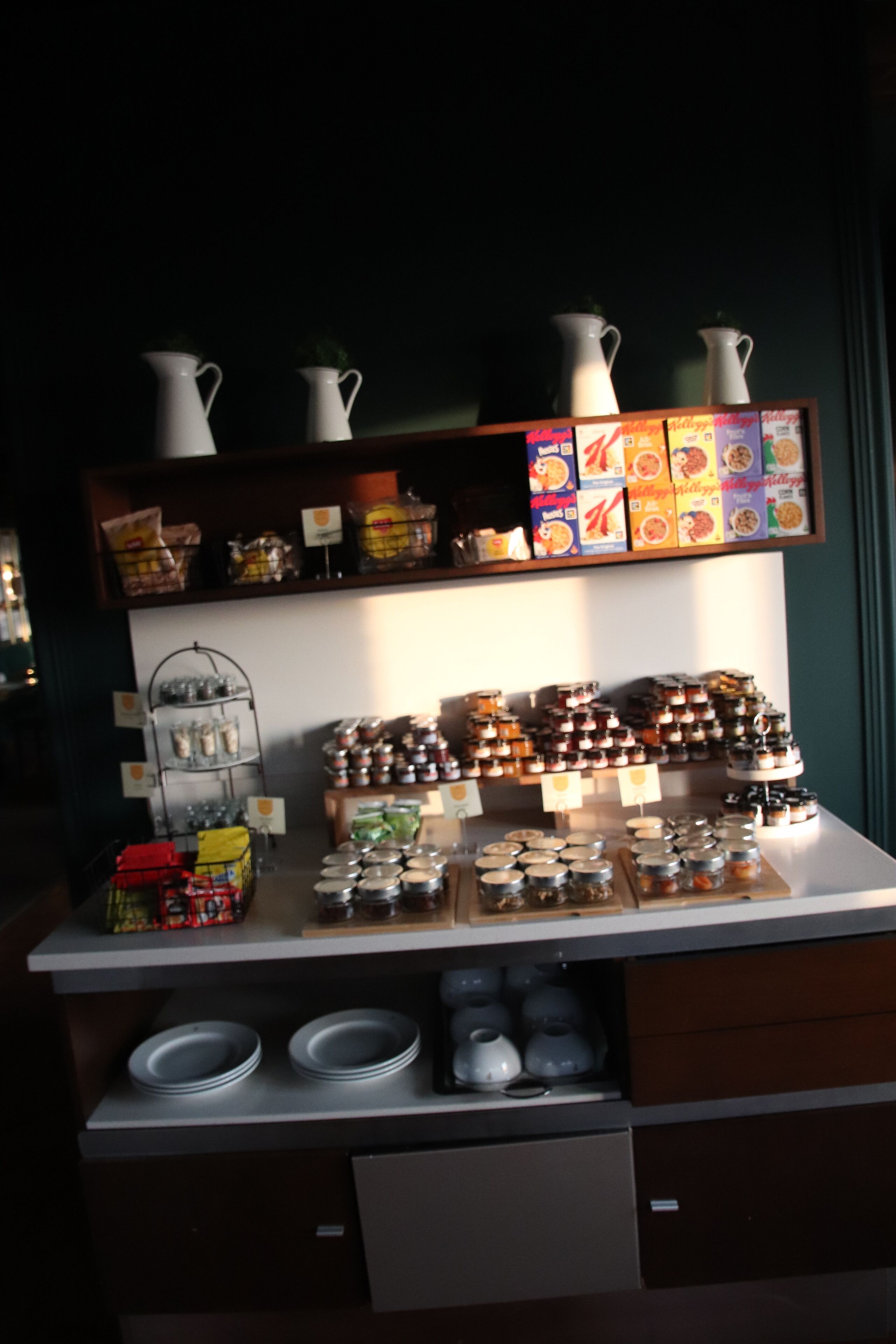 A display of food items and condiments, including jars and boxes, on a counter.