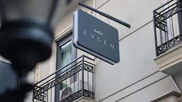 A hotel sign with the name 'Hotel Evensen' mounted on a building facade.