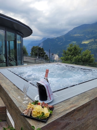 Outdoor spa tub. Hotel Victoria Lauberhorn Wengen, a Faern Collection Hotel