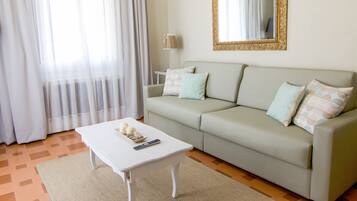 Standard Suite | Living area | 25-inch flat-screen TV with satellite channels, TV