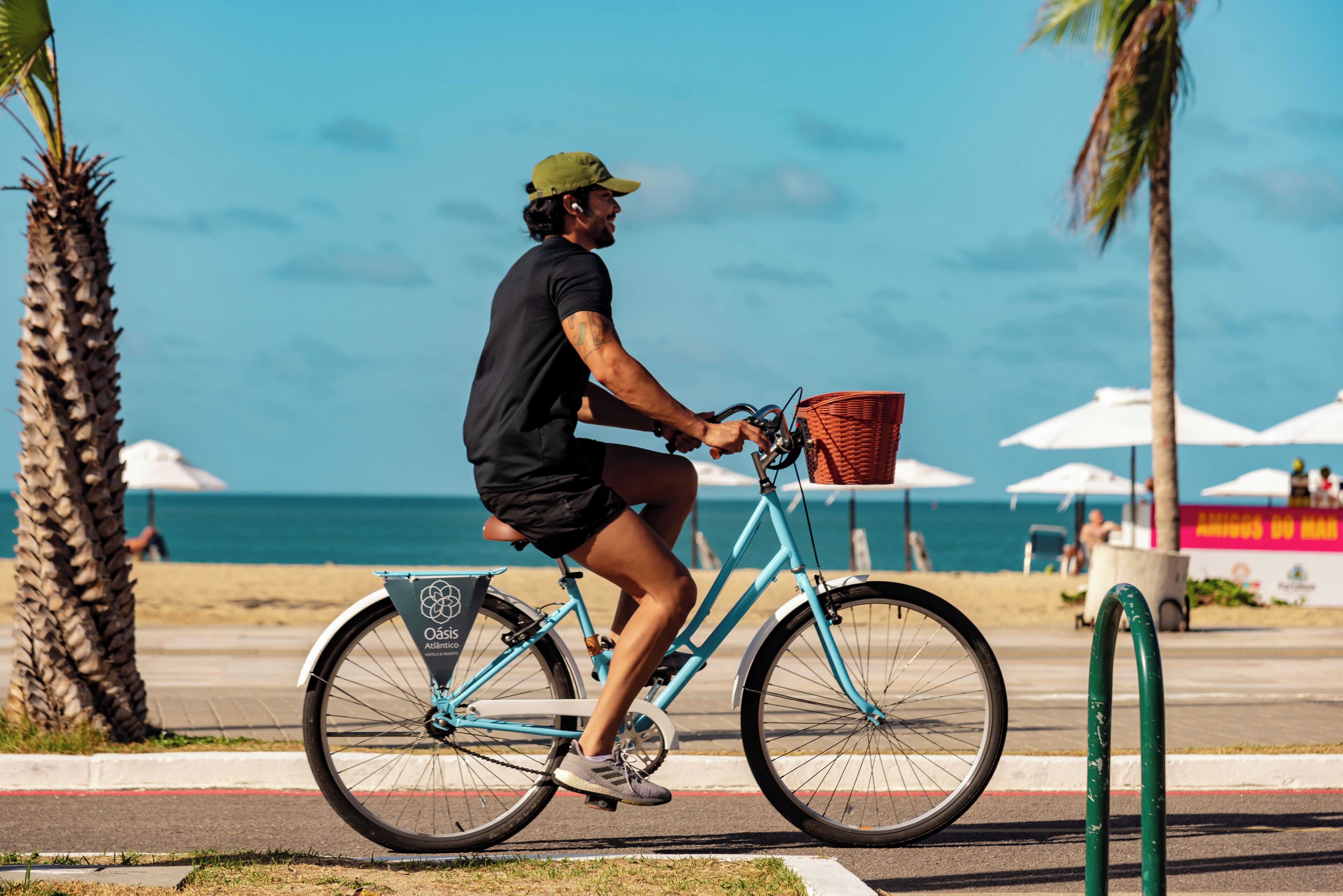A person riding a bicycle with a basket on a sunny day.