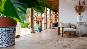 A wooden floor, a white chair, a potted plant, and a vase with pampas grass. - Costa Bodrum City (Bodrum)