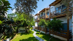 A modern building with a wooden deck and a gravel path. - Costa Bodrum City (Bodrum)