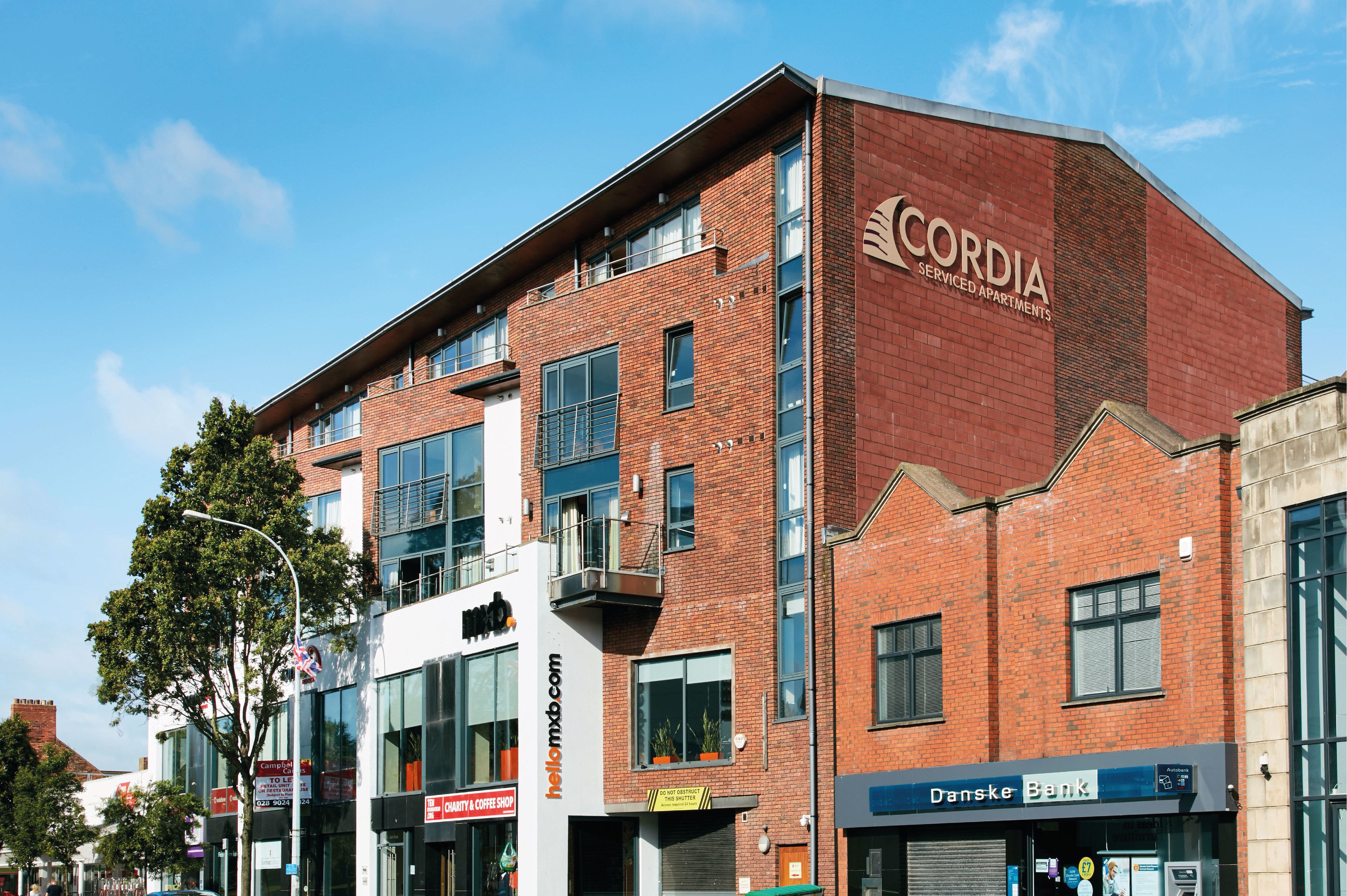 A multi-story building with a prominent 'CORDIA' sign, indicating it is a serviced apartment complex.