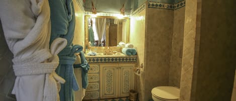 A bathroom with a checkered floor, a sink with a mirror, and a toilet.