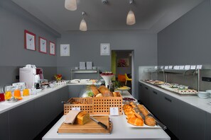 A buffet setup with various food items and beverages.