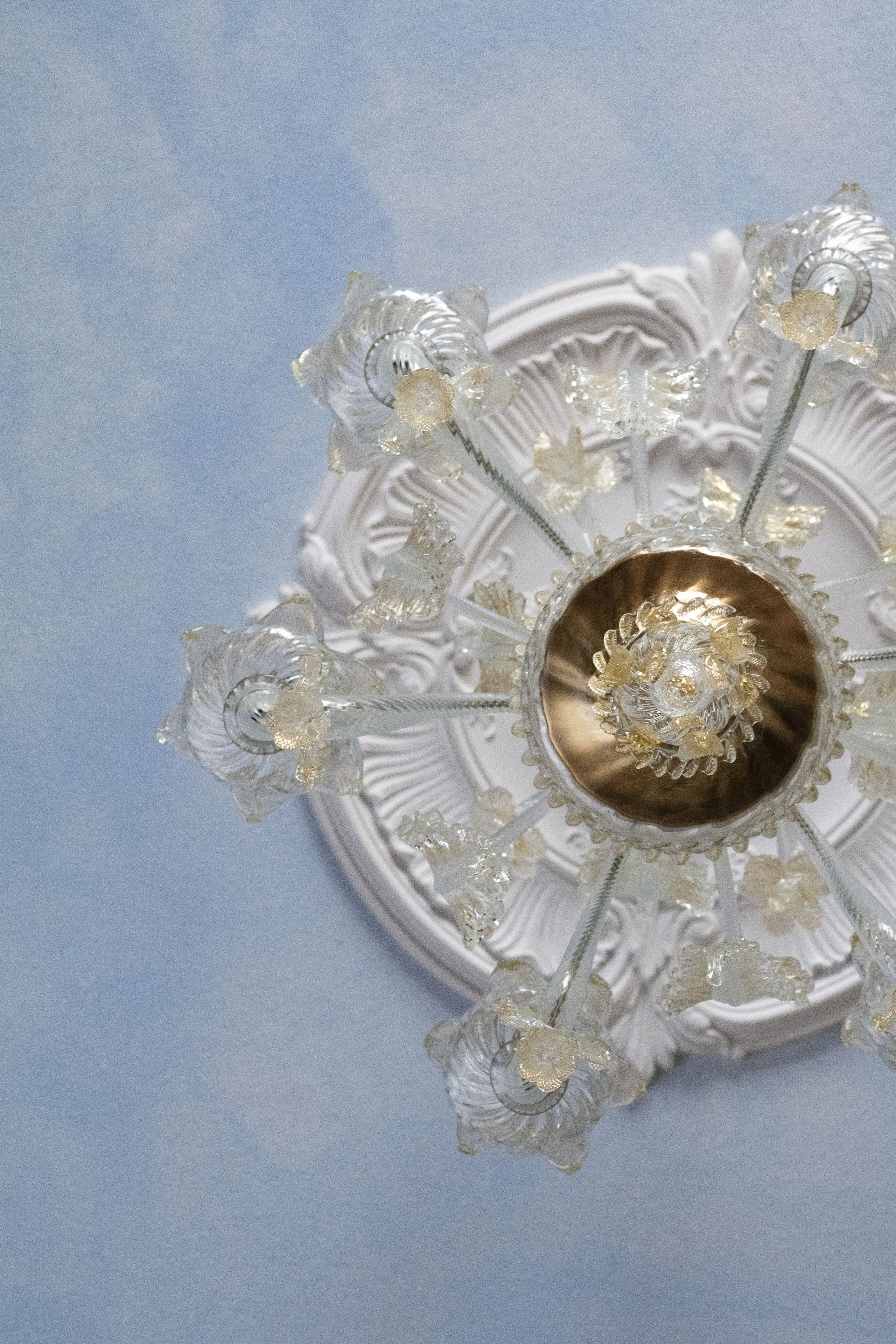 A ceiling with a central decorative element surrounded by crystal-like structures.