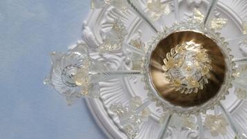 A ceiling with a central decorative element surrounded by crystal-like structures.