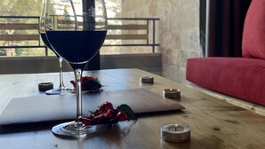 A table with a wine glass, candles, and a menu. - Faraya Village Club (Faraya)